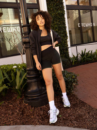 a person wearing black/green tank top and black/green shorts