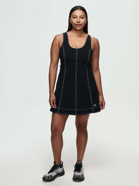 Model wearing the Energy Dress featuring built-in shorts, A-line silhouette, and hand-embroidered OV signature.