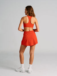 a person wearing an orange skort