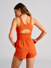 a person wearing an orange tank top