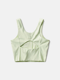 a person wearing a light yellow tank top