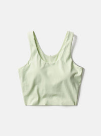 a person wearing a light yellow tank top