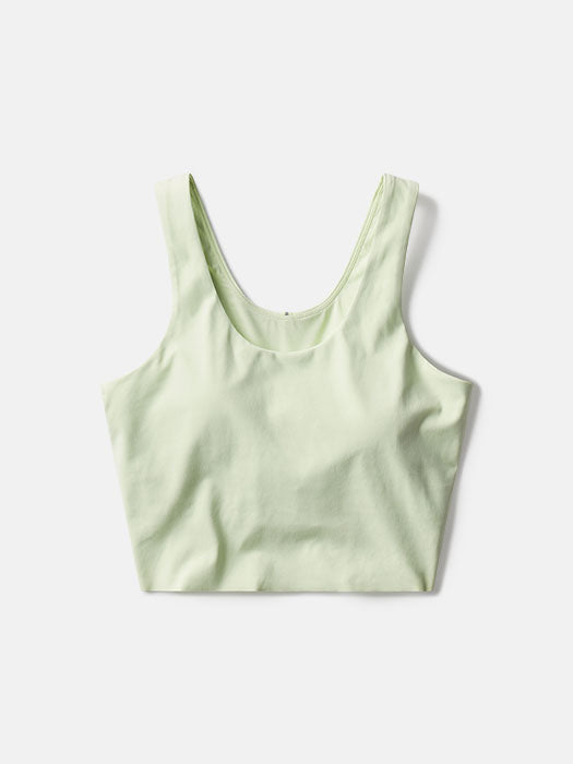 a person wearing a light yellow tank top
