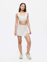 Court Skort 2.5" shown on model in light gray, featuring signature silicone gripper band and embroidered logo.