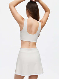 Back view of a model wearing a stylish Court Skort 2.5" with a matching top, showcasing the textured fabric.