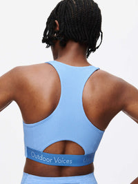 Back view of the Doing Things Bra showcasing breathable mesh and Outdoor Voices logo on the elastic band.