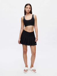 Model wearing the Doing Things 3" Skort with built-in shorts and a stylish pleated design.