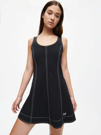 Model wearing the Energy Dress featuring an A-line silhouette and contrast topstitching in black fabric.