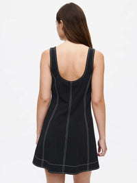 Back view of a model wearing the Energy Dress, showcasing the A-line silhouette and contrast topstitching.