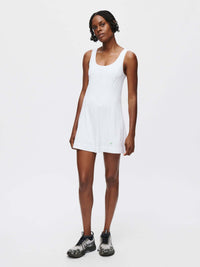 Model wearing the Energy Dress in white, showcasing its sporty style and breathable design.