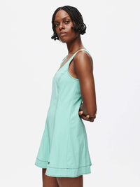 A model showcasing the Energy Dress, featuring A-line silhouette and built-in shorts in a fresh mint color.
