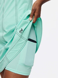 Hand showing pocket in Energy Dress featuring built-in shorts, ideal for workouts and active movement.