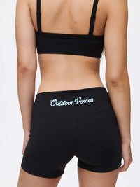 Woman wearing Outdoor Voices Gemini 3" Short, showcasing the logo on the back waistband.
