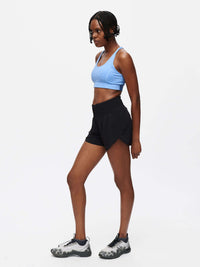 Model in a side view wearing LightSpeed 3" Short in Black with a budge-proof band and pockets, for running.