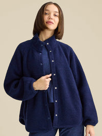 a person wearing a navy jacket