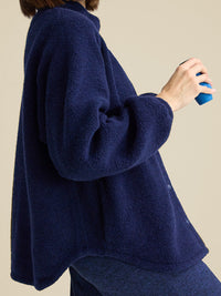 a person wearing a navy jacket