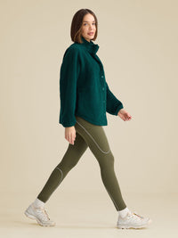 a person wearing a green jacket