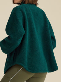 a person wearing a green jacket