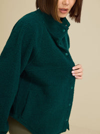 a person wearing a green jacket