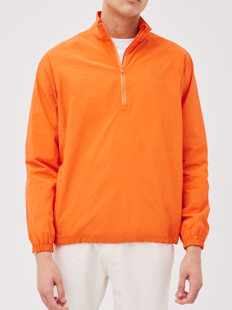 a person wearing an orange jacket