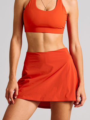 a person wearing an orange skort