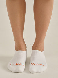 OV No Show Sock CL worn on feet, featuring 'Outdoors Voices' branding in orange.