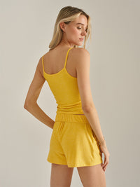 a person wearing a yellow tank top