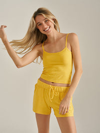 a person wearing a yellow tank top