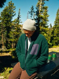 a person wearing a green jacket