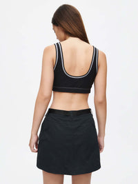 Model wearing Outdoor 4" Skort from the back, featuring adjustable waistband and TechTwill fabric.