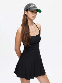 Sporty Dress model wearing a black sleeveless dress with a cap, showcasing a stylish sporty look.