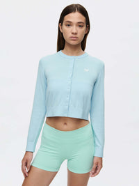 Model wearing Sugar Cardigan in Light Blue, featuring button-down front and soft cotton cashmere blend.