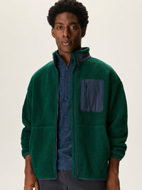a person wearing a green jacket