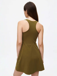 Back view of a woman in a Volley Dress showcasing its fit-and-flare silhouette and supportive SuperForm fabric.