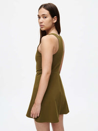 Model wearing a Volley Dress in olive green, showcasing the fit-and-flare silhouette from the back.