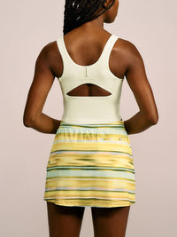 a person wearing a light yellow tank top