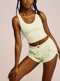 a person wearing a light yellow tank top