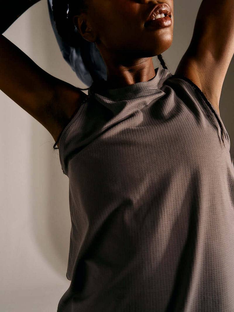 a person wearing a grey tank top