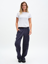 Waffle Baby Tee in White – front full-length view styled with navy track pants