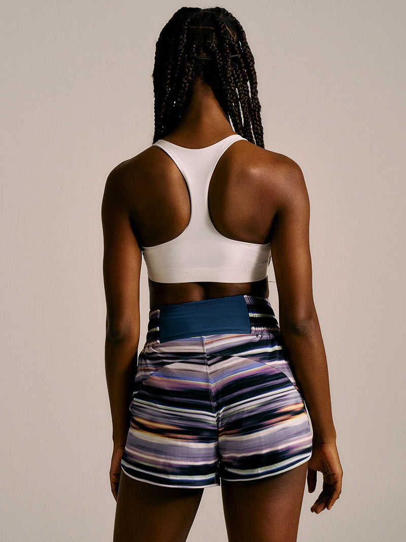 a person wearing purple patterned shorts