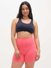 Model posing in Echo 5.5" Short in Cotton Candy, featuring a tall waistband and elastic top edge for support.