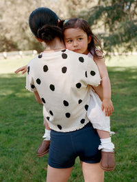 Model carrying a child in the Echo 3.5" Short, featuring a high rise and supportive stretch for comfort.