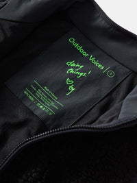 Interior tag of Candy Fleece Jacket showing care instructions and 'doing things' message in green ink.