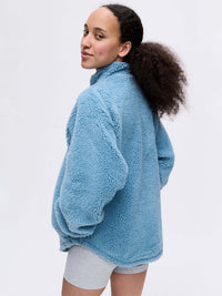 Model in blue Candy Fleece Snap Jacket, with the soft fleece texture and oversized fit.