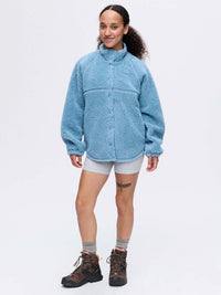 Model wearing Candy Fleece Snap Jacket in Light Blue, featuring a soft, textured fabric and oversized fit.