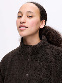 Model posing in Candy Fleece Snap Jacket in Chocolate Brown, featuring a soft fleece texture and snap front.
