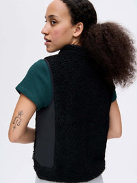 Back view of Candy Fleece Vest in Black, featuring contrast technical nylon side panels and a warm fleece texture.