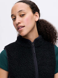 Model wearing Candy Fleece Vest in Black, featuring a mock neck and soft textured fabric.