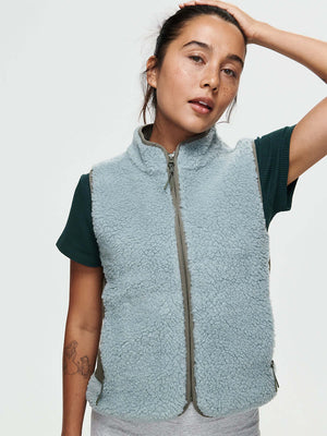 Model wearing Candy Fleece Vest in Light Blue, showing the soft fleece texture and mock neck.