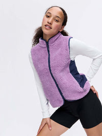 Model posing in Candy Fleece Vest, showing soft fleece texture and contrast nylon side panels.